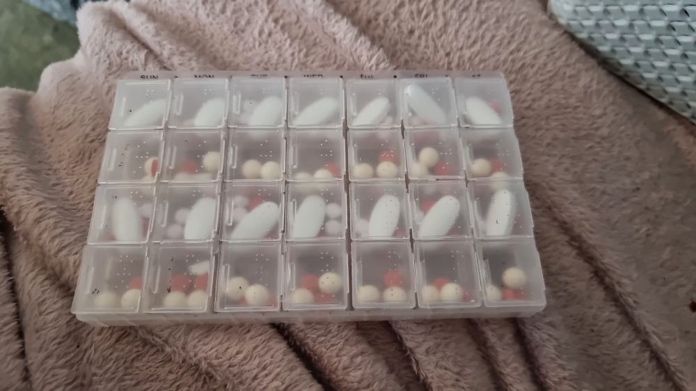 picture of a pill box filled with all kinds of meds