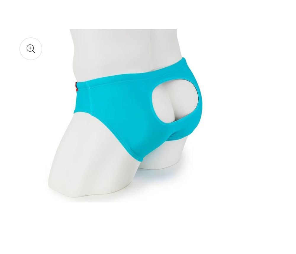 A mannequin wearing a bright turquoise speedo-style swimsuit with a hole in the back, designed to show a lot of cheek.
