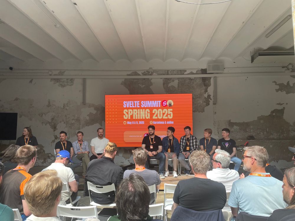 Photo of the Svelte core maintainers on the stage sitting next together during the fireside chat.