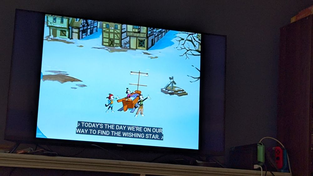 A long pan of the Warner siblings continuing their song in the town square thus failing to keep the wishing star a secret. Pesky first come only served wishing stars. 