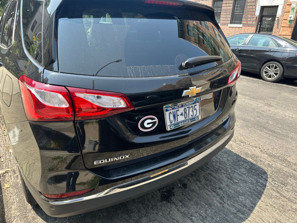 chevy equinox has a georgia G sticker next to its new york plate