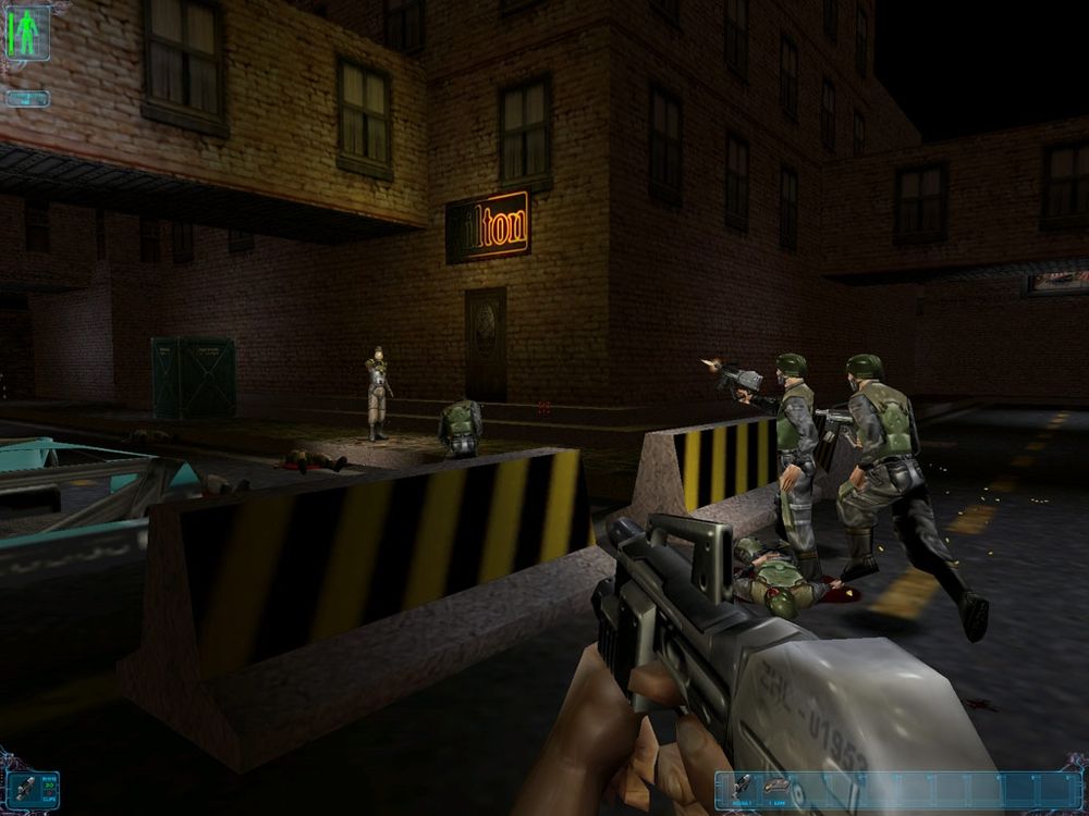 The player joins the firefight with an assault rifle. A burnt out neon sign marks the entrance to the 'ton hotel.