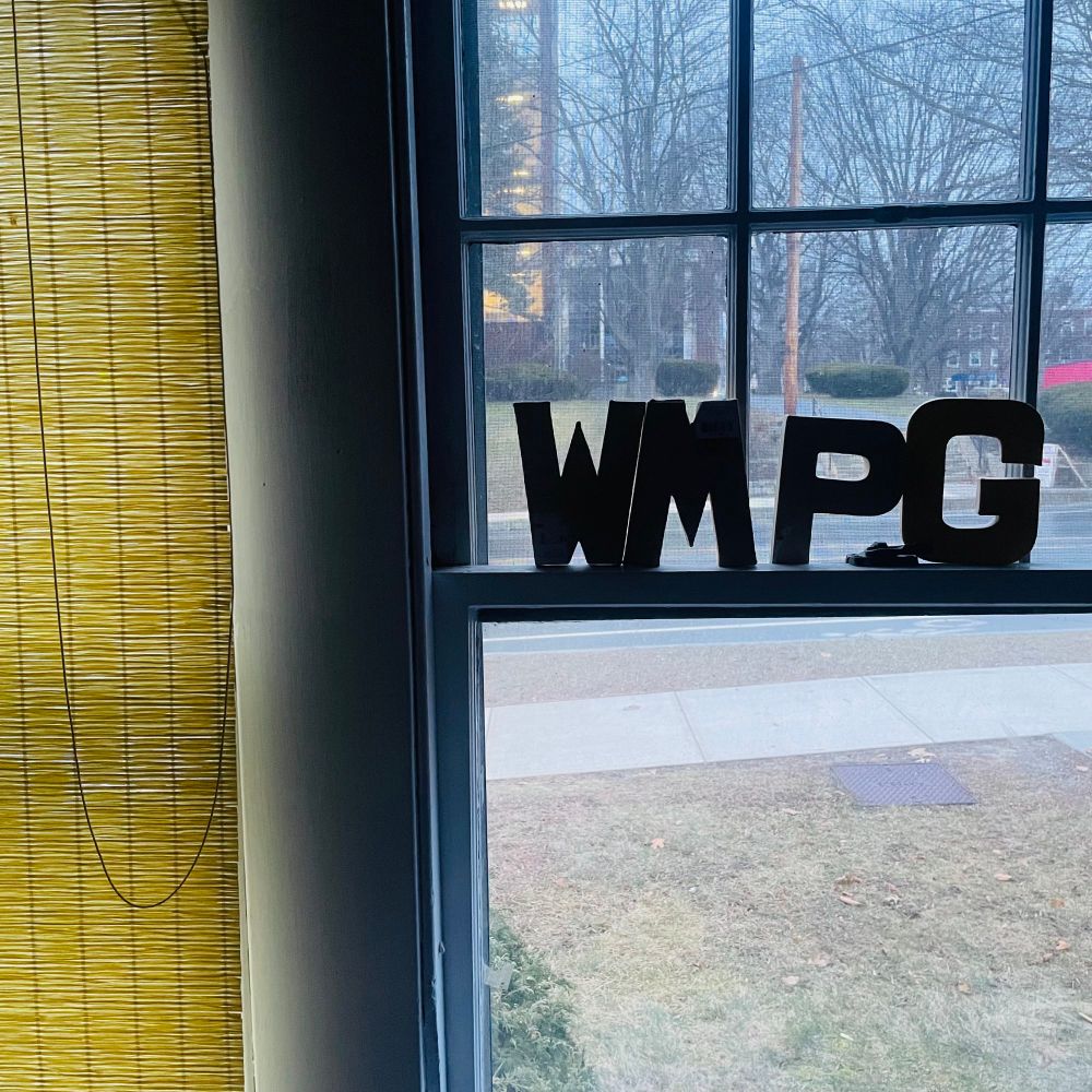 window of WMPG showing call letters and a drab patch of April lawn 