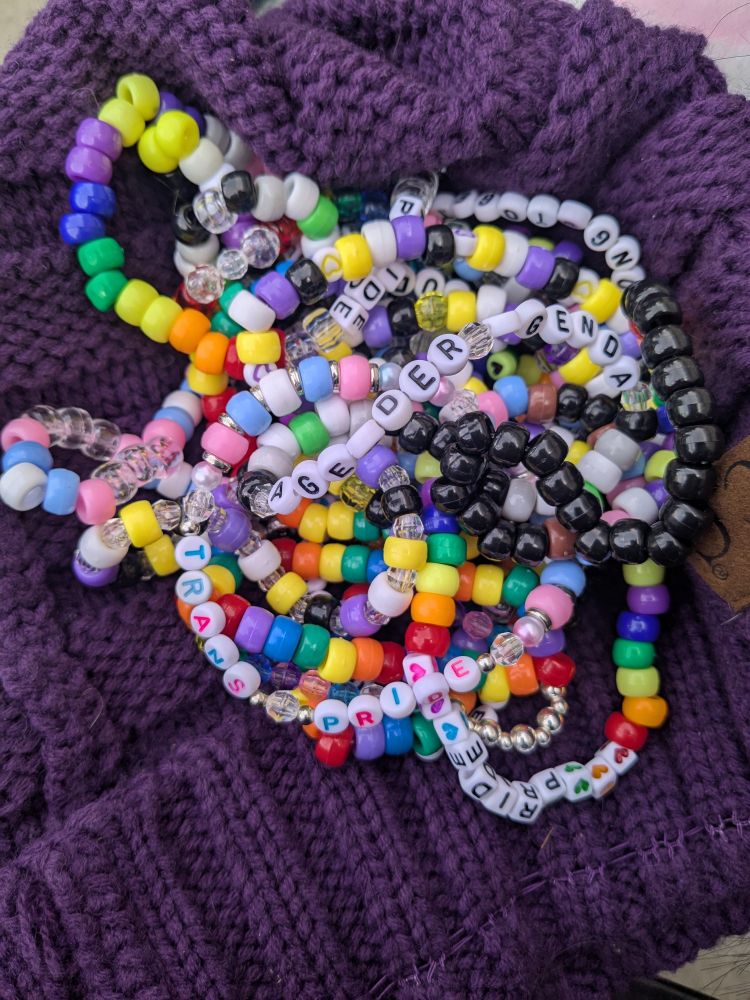 a pile of pride kandi bracelets