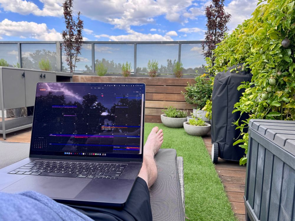 A fat guy lays on a lounge chair with a laptop on his legs