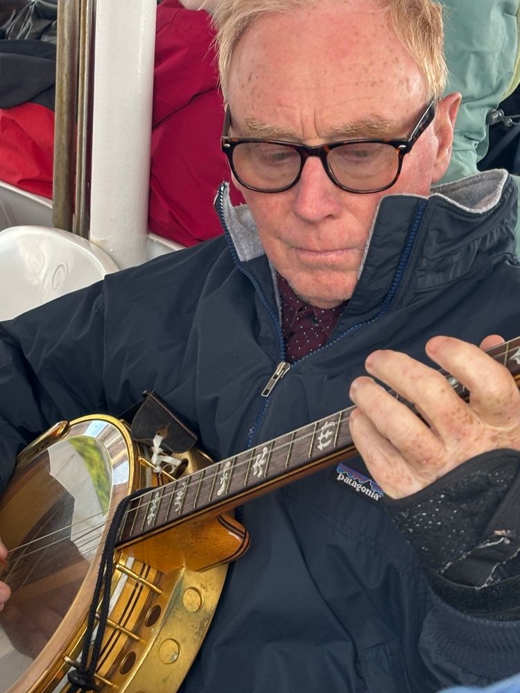 Musician Michael Black playing the banjo.