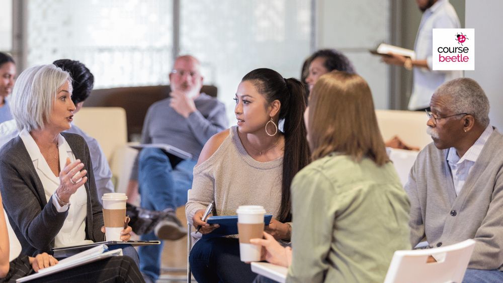 A group of professionals sit together and discuss ideas from their recent Course Beetle training