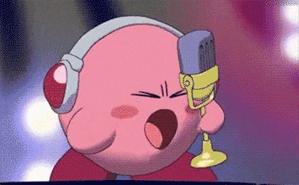 kirby is singing into a microphone wearing headphones .