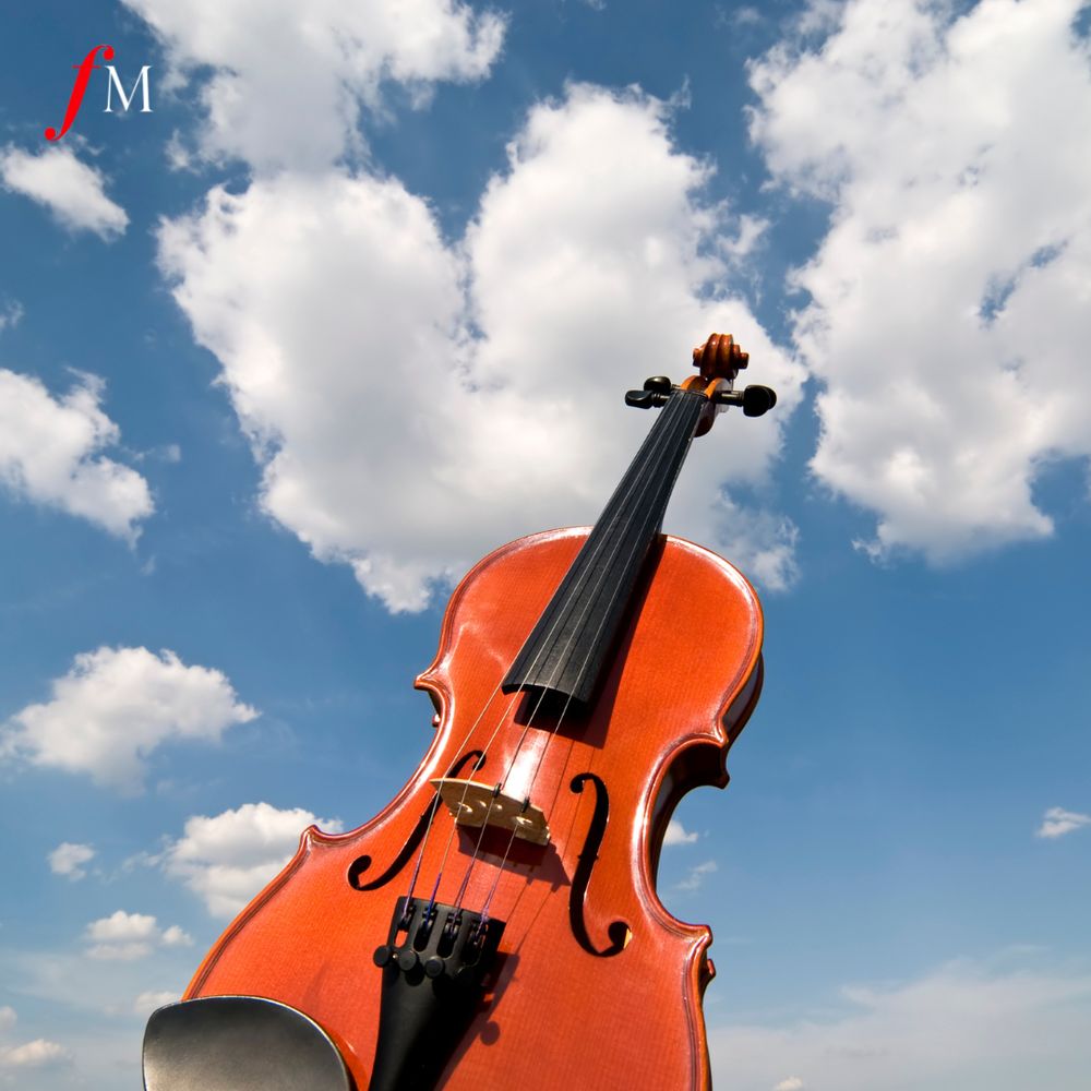 A violin with a blue sky in the background