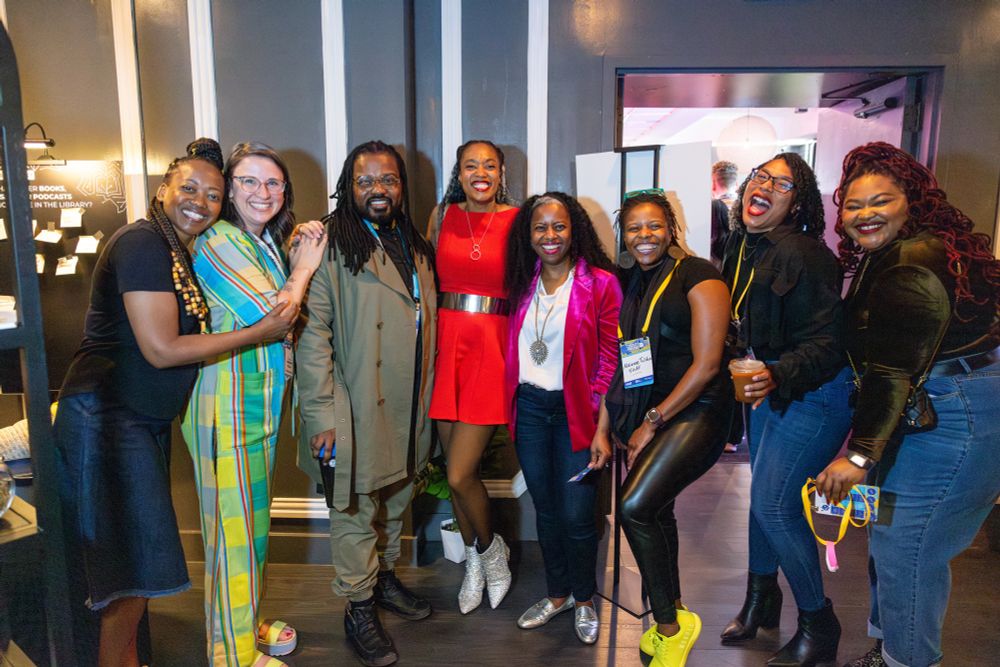 8 people smile and pose for the camera