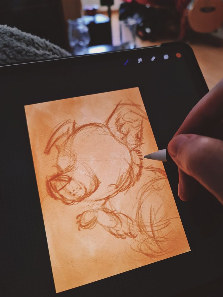 Photo of an iPad showing the sketch in progress of a puppy, done in Procreate