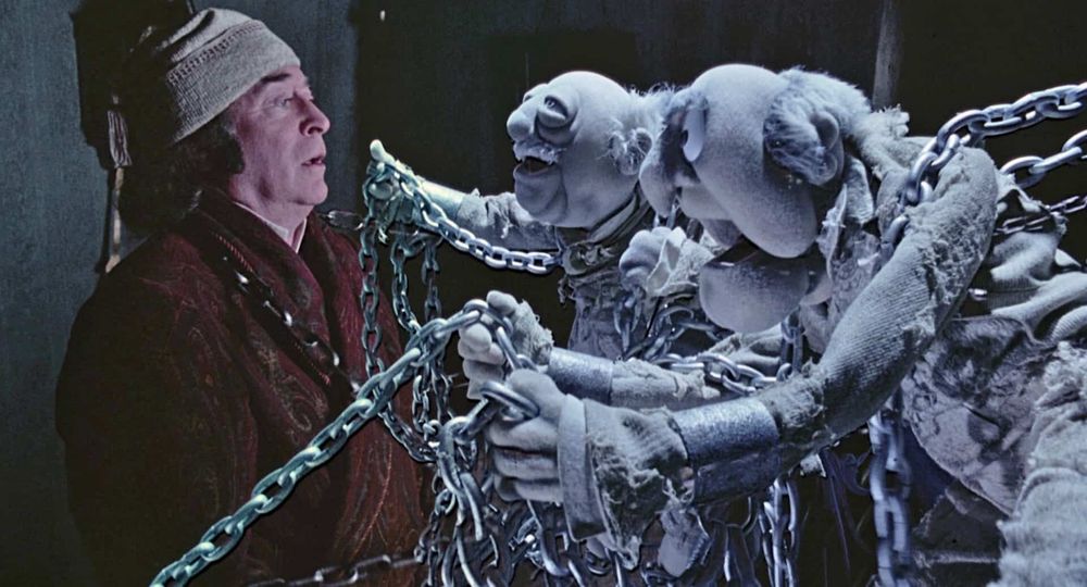 Michael Caine being taunted by the ghosts of Statler and Waldorf in The Muppet Christmas Carol
