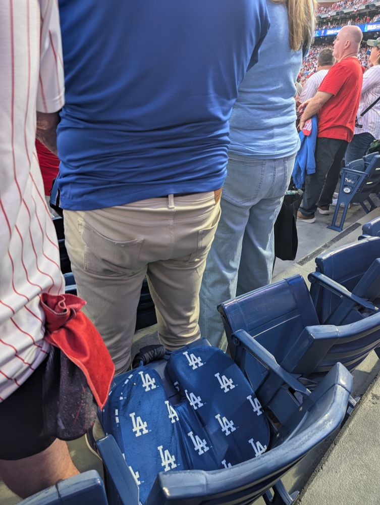 2 folks in front of me are Dodgers fans. Pictured: one fan's LA seat cushion