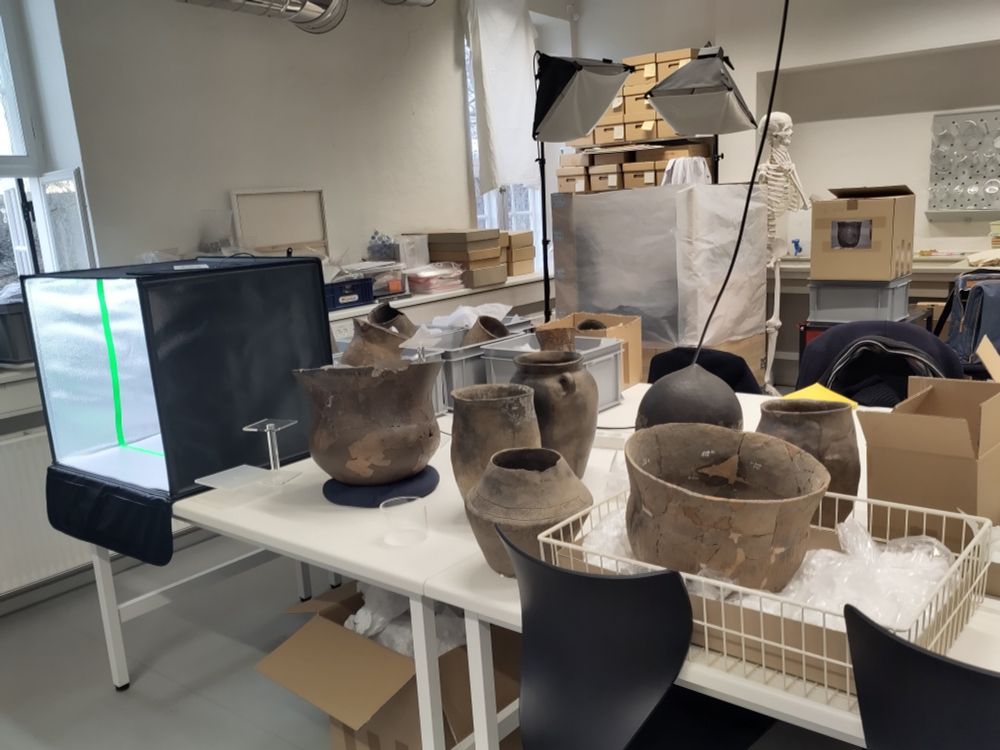 Table with old ceramics. On the left a black box where the ceramics will be presented