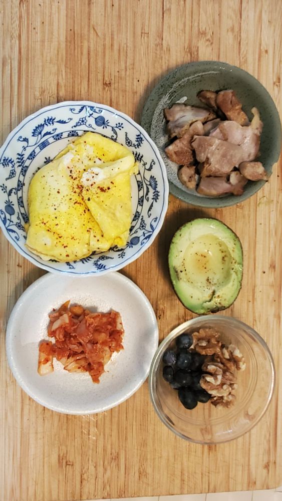 Two scrambled egds. 2 oz of roast pork. 1oz of kimchee, 1/2 avocado 1/5 cup walnuts. 1/5 cup blueberries. 