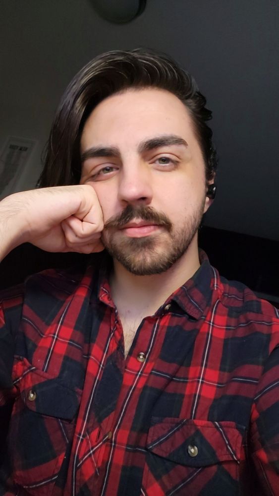 A picture of me with red flannel, and my long hair hanging off one side of my face