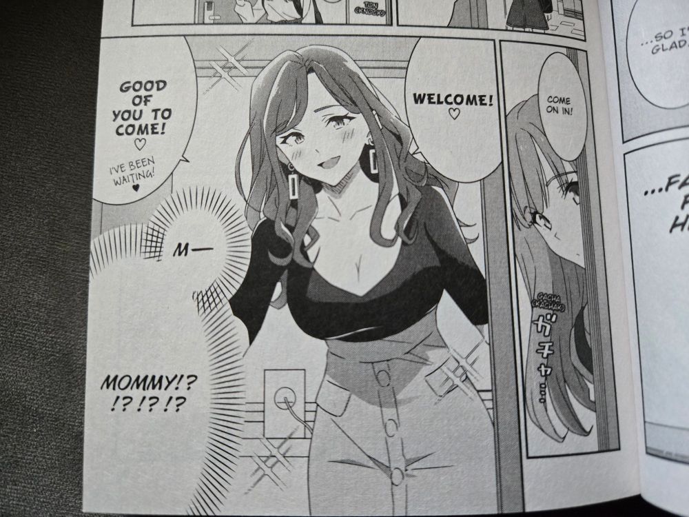 more manga. on the rightmost panel we can see the long blond-haired girl from earlier peeking her head in through a door as a voice out of frame says "come on in!" 

in the next frame a middle-aged lady with longer, wavy brown hair who's wearing a black top that accentuates her curves (and, let's be honest, her breasts) says "welcome! ♡" "good of you to come! ♡ i've been waiting! ♡" while our protagonist thinks to herself "m-mommy!?!?!?!?"