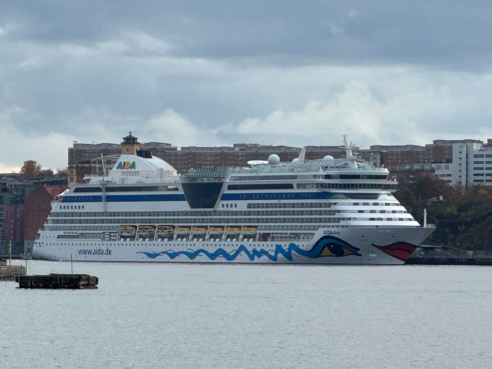 A cruise liner with a female face with big red lips painted on the bow