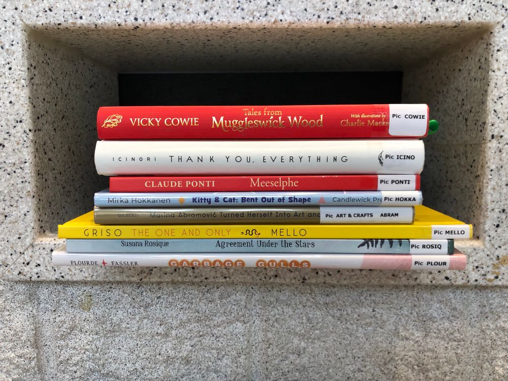 Library returns including Garbage Gulls at bottom of stack. 