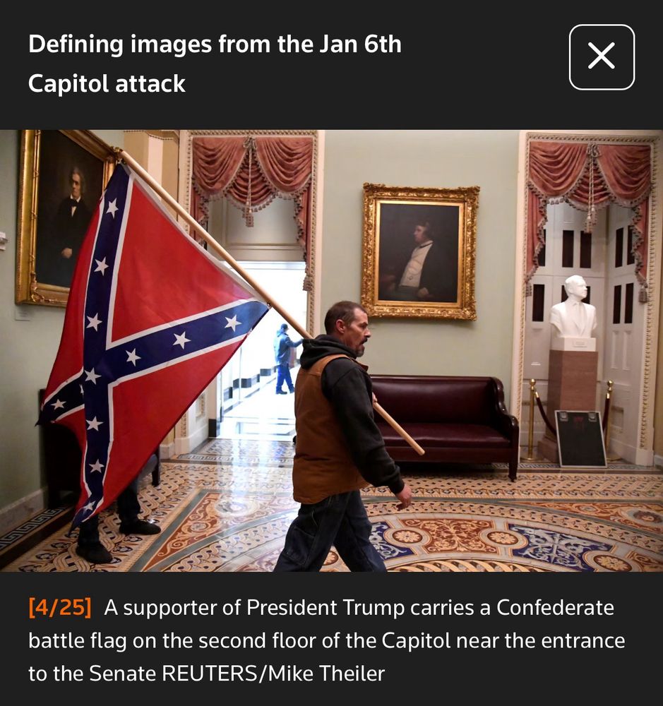 January 6th insurrectionist, carries a Confederate flag on the second floor of the Capitol near the entrance to the Senate. Reuters: Mike Theiler