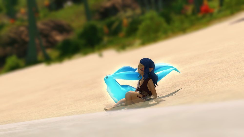 A screenshot from FFXIV. A lalafell with dark blue hair and tan skin sits on the shore, partly in the water; her eyes are closed and she has a faint smile, relaxed. Next to her sits a blue carbuncle, which is looking up and away, seeming curious.