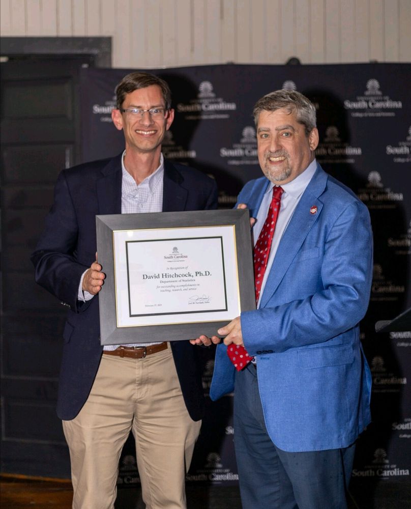 Prof. David Hitchcock at the College of Arts and Sciences Tenure & Promotion reception being presented with a certificate by Dean Joel Samuels. Dr. Hitchcock was recently promoted from Associate to Full Professor of Statistics.