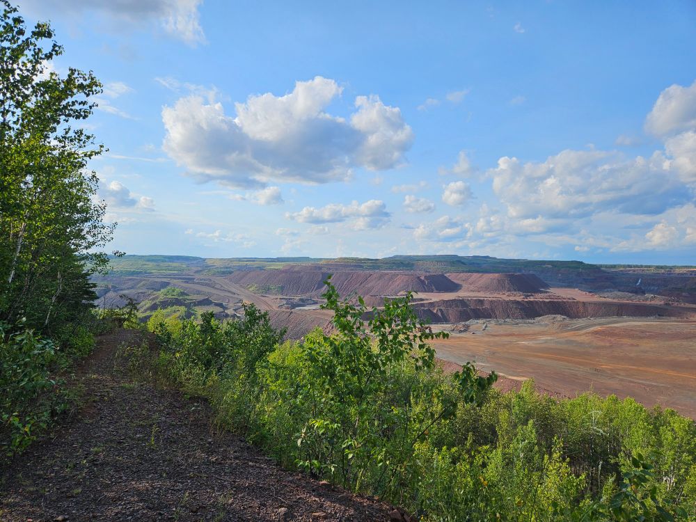 Hull Rust mine, one of the largest operating open pit mines in the world. Artificial hills made of mine dumps and flat plateaus made Artificially by tractor traffic