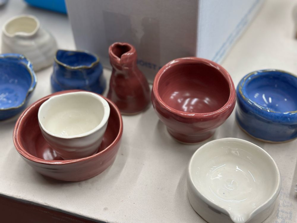 Photo of several misshapen ceramic pots on a table