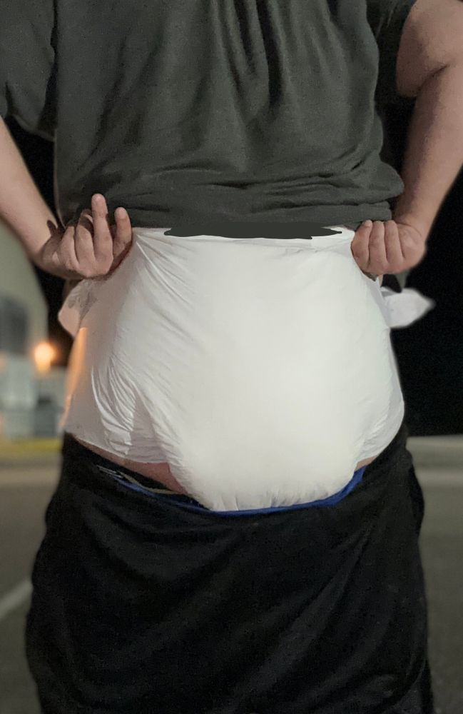 A tugging view to show the heft of the diaper 