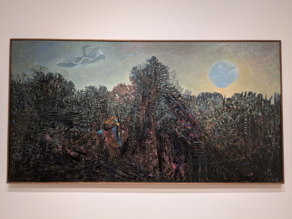 Photograph of Max Ernst painting titled "A moment of calm".

It depicts a sharp and harsh landscape, with dangerous metallic looking creatures, juxtaposed against a pleasant, but eerie, looking sunset.