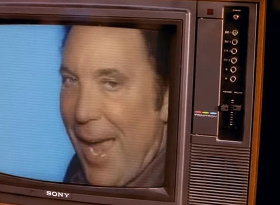 Tom Jones in the Sex Bomb video, singing on an old fashioned TV.