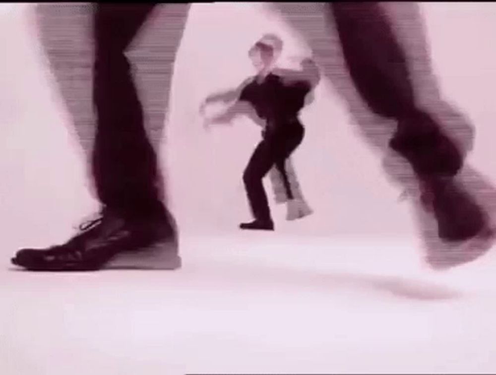 a blurry picture of a person dancing on a white background .