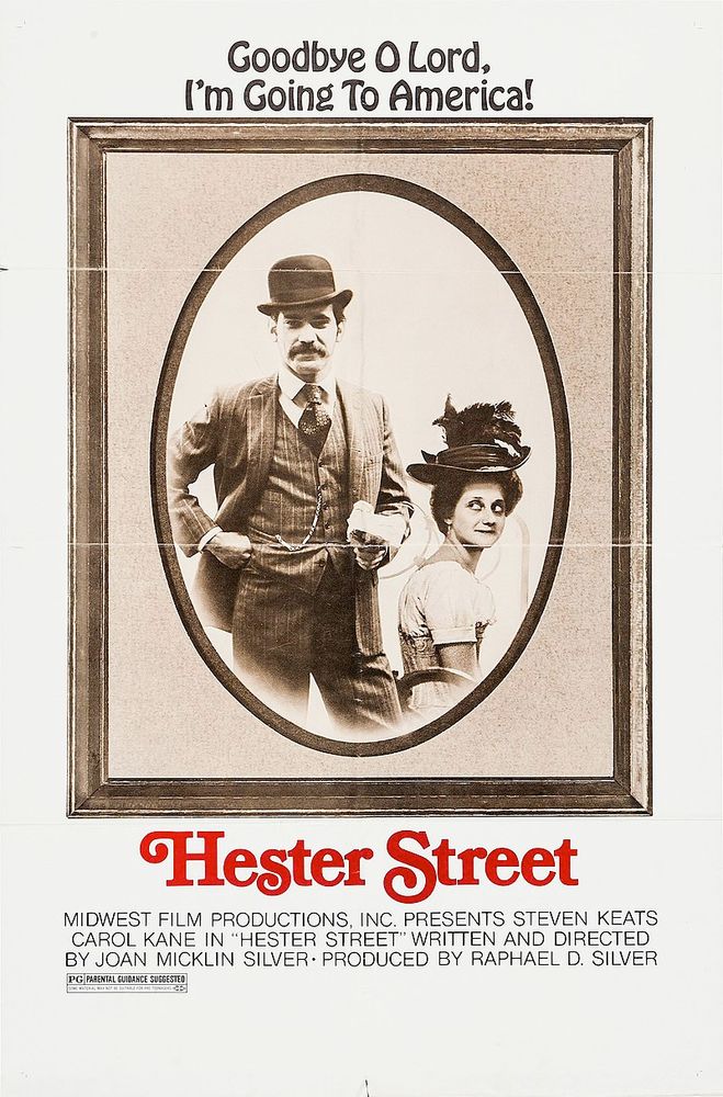 Poster for the 1975 film Hester Street, starring Steven Keats and Carol Kane, directed by Joan Micklin Silver. A framed black and white photo of a man standing looking at the camera and a seated woman facing away from the man but looking back at him. The tagline is 
