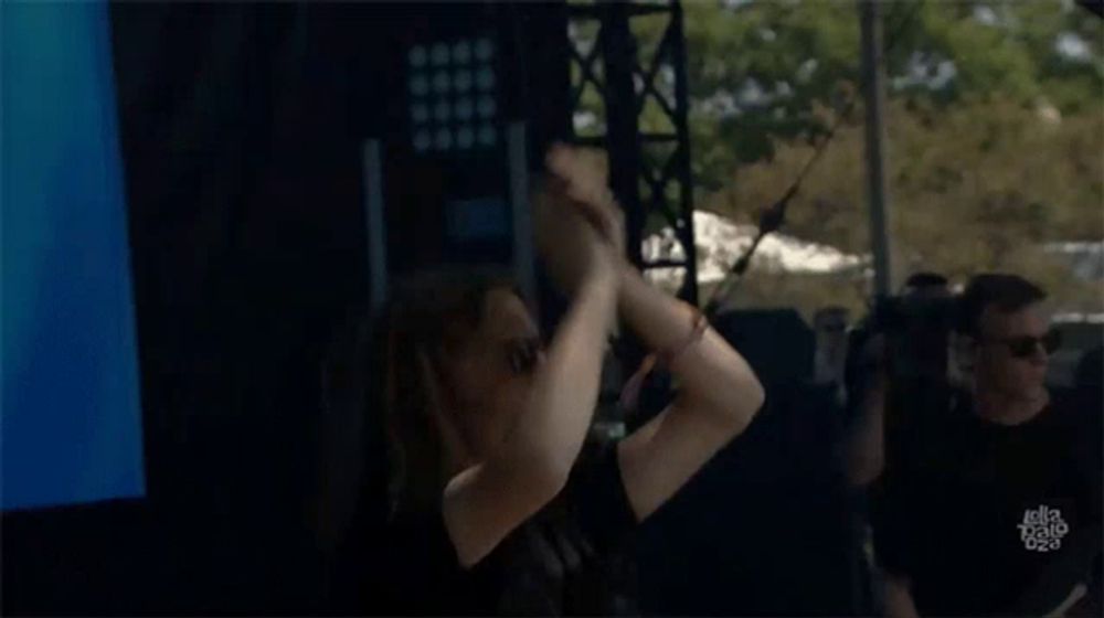 a man is dancing in front of a screen that says ' jellyfish ' on it