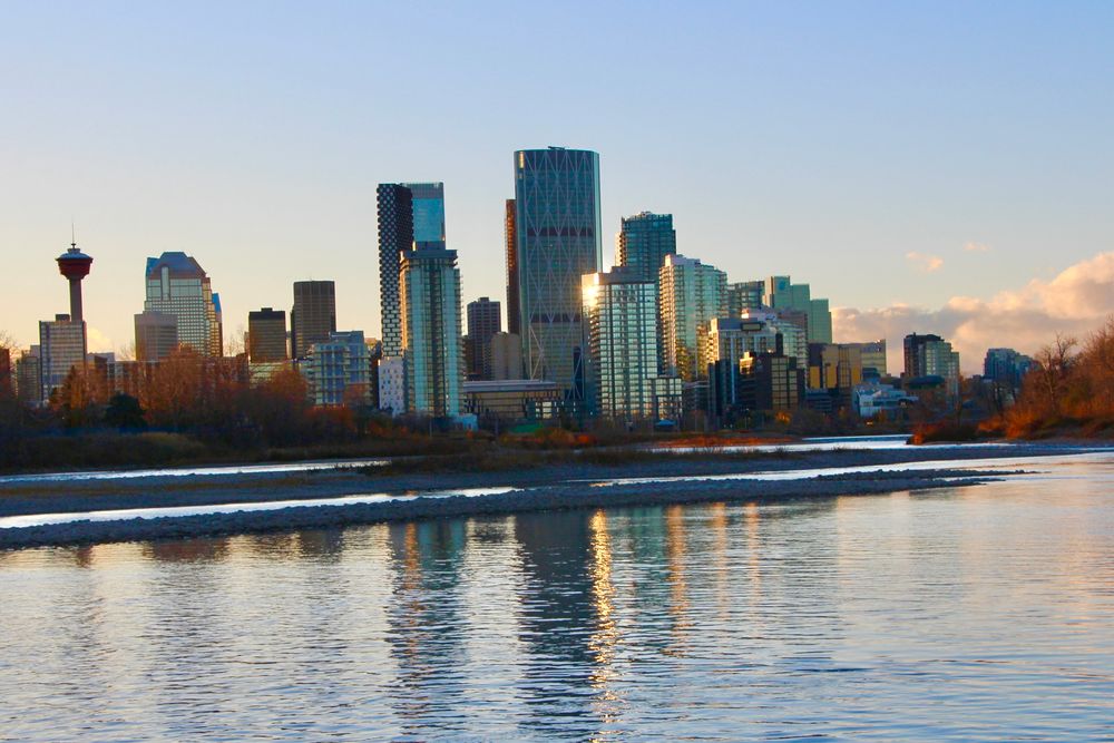 The City of Calgary, seen across the Bow River, just prior to sunset. 