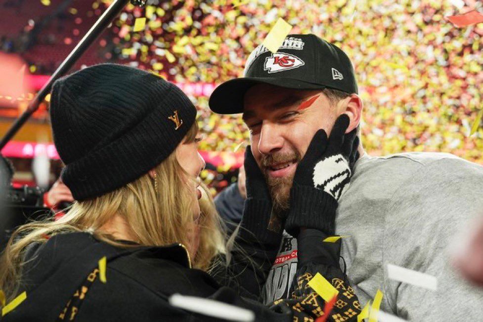 taylor holding Travis’s face at the afc championship game 