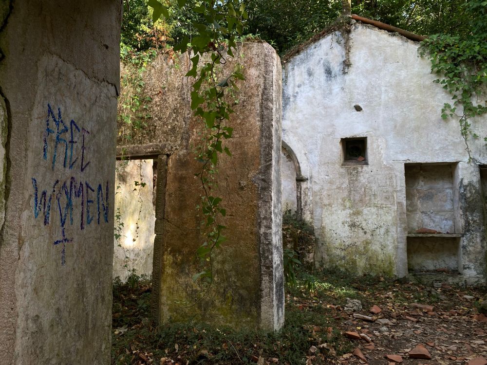 ruins of a 17th century hermitage. there is some graffiti that says “free women”.