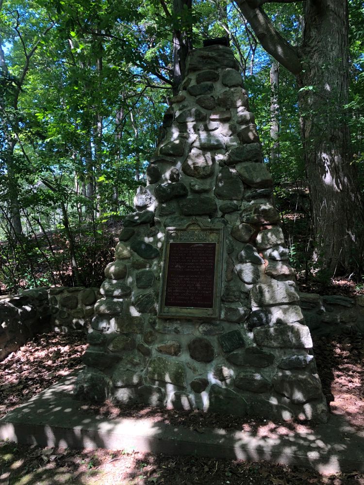 A rock cairn with a plaque marking the wintering site.