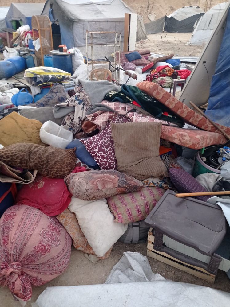 An assortment of belongings scattered in heaps on the ground.