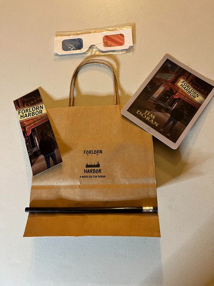 PIcture of bag, boookmark, pencil, 3D glasses, and postcard.