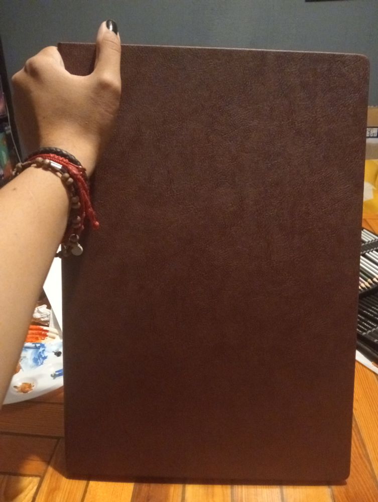 Me holding an A3 size sketchbook (it's big)
