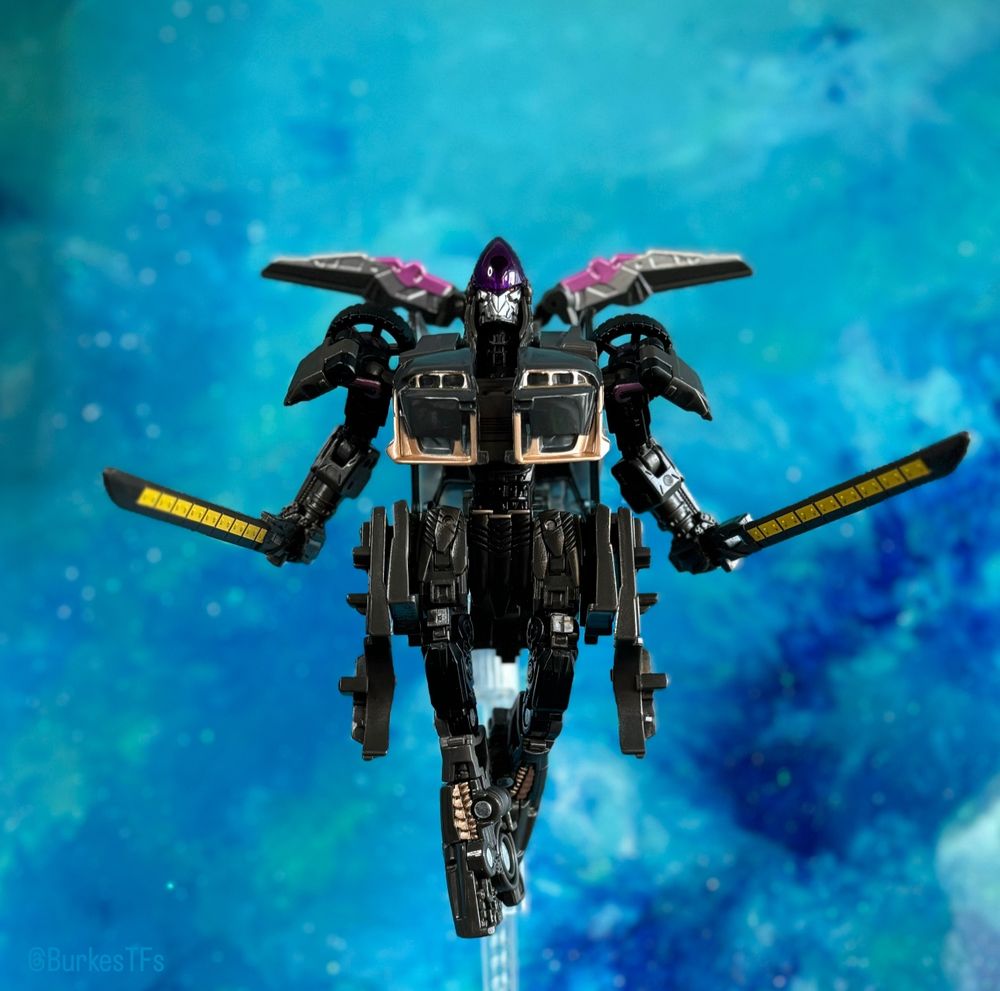 Rise of the beasts studio series Nightbird in robot mode on a flight stand with the DNA design upgrade kit.