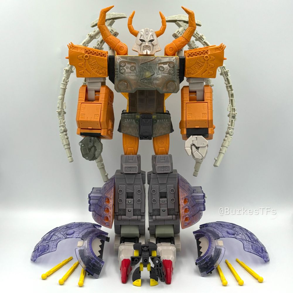 A 2003 unpainted pre-production Armada Unicron in plastic colors that closely resemble the retail colors. The translucent plastic on the chest, hand, and crotch plate is a darker, smokier, and softer color than the retail version. The tips of the feet also have red paint applied.