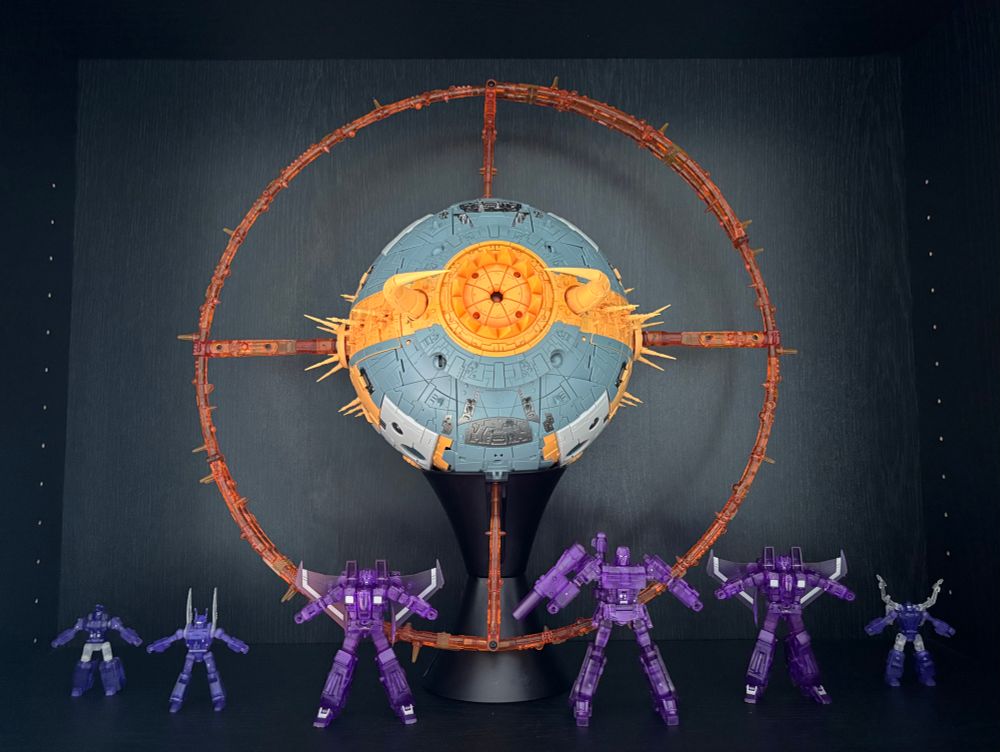 A display of 3rd party Transformers. 01-Studio Cell (cartoon colors) with translucent rings from 01S01E Overmind. Also present are Newage Lucky Draw Megatron, two lucky draw seekers, and lucky draw insecticons.