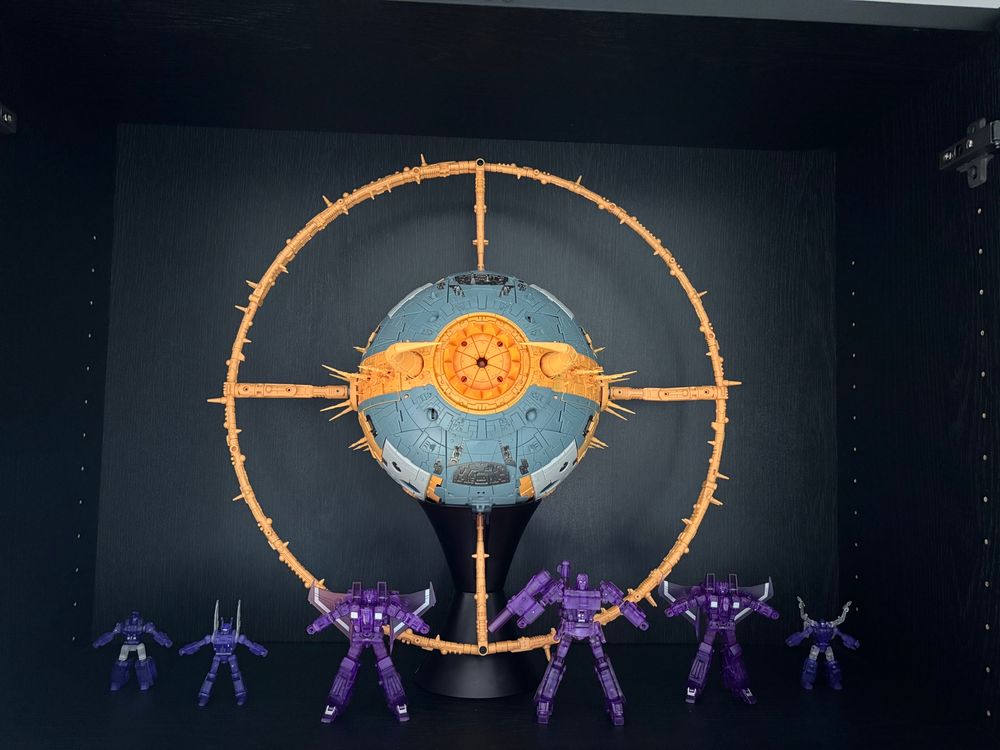 A display of 3rd party Transformers. 01-Studio Cell (cartoon colors) with ARMOR AM-01 ring upgrade kit. Also present are Newage Lucky Draw Megatron, two lucky draw seekers, and lucky draw insecticons.