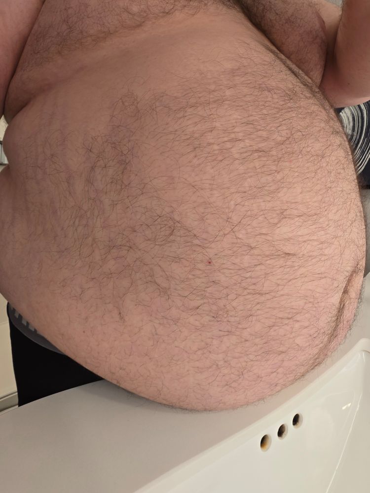 Photo of my belly resting on a counter from the side