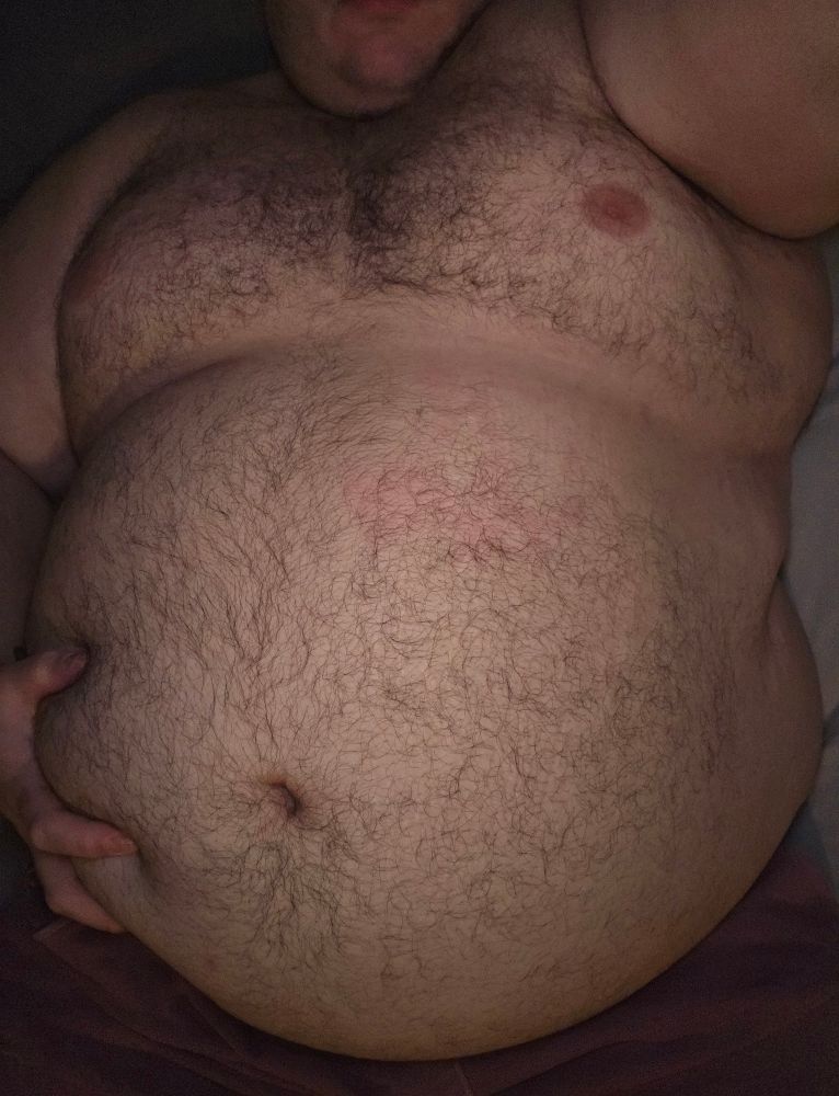 Photo of me shirtless laying on my back in bed