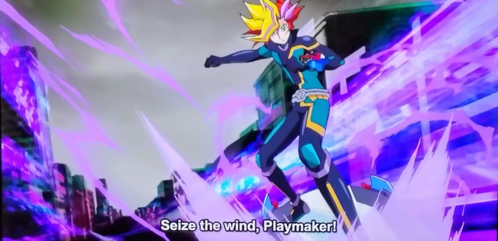 Cruddly off camera snap of Yugioh VRAINs on my TV of the main character Playmaker riding a board literally surfing the web at the start of this show's version of a Speed Duel lol