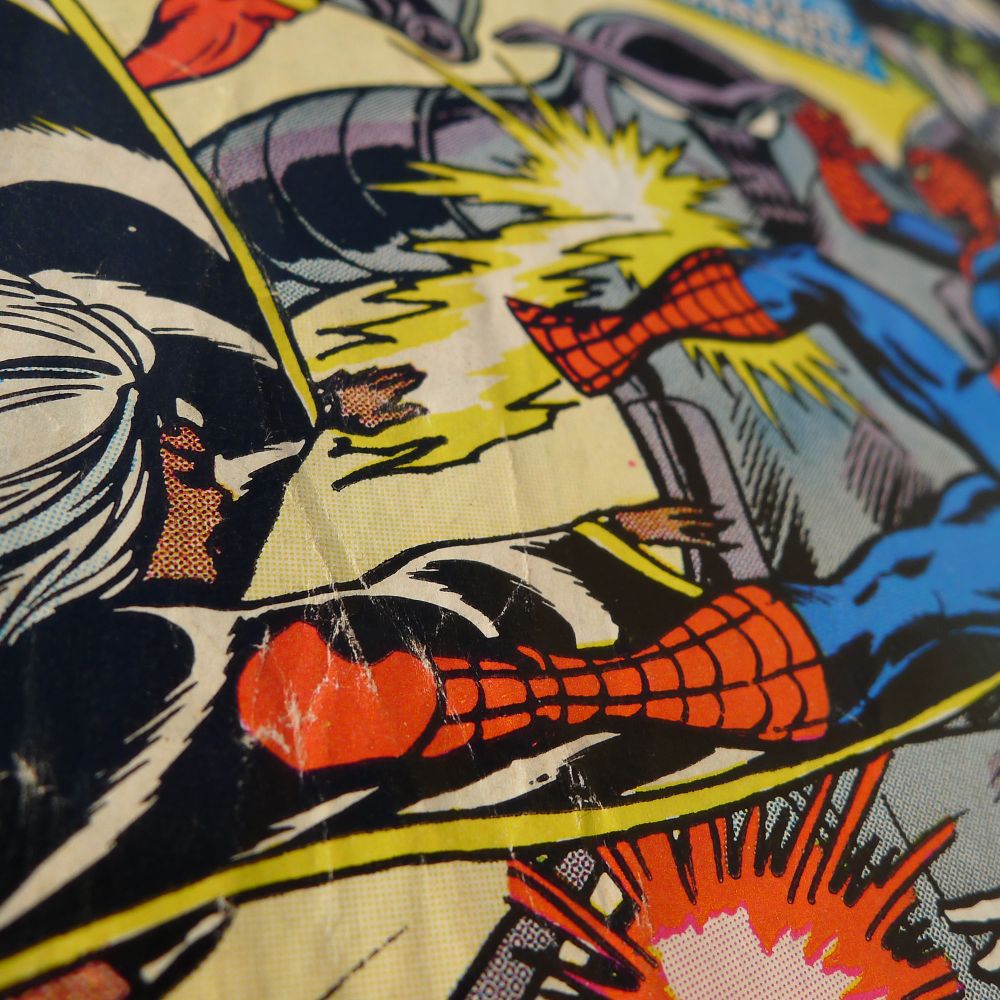 The X-Man Storm shooting lightning at a giant robot and, apparently, Spider-Man's boots. Extreme angle.