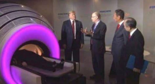 A fake photo of Trump and three other people in suits standing next to a futuristic-looking MRI machine with a ring of purple light.